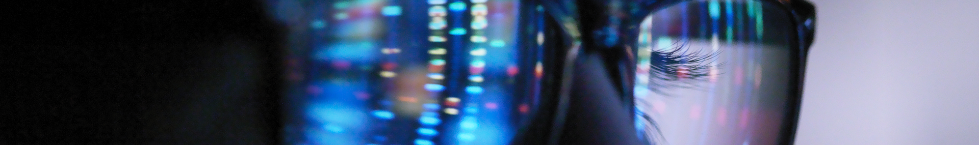 A computer screen reflected in someone's glasses