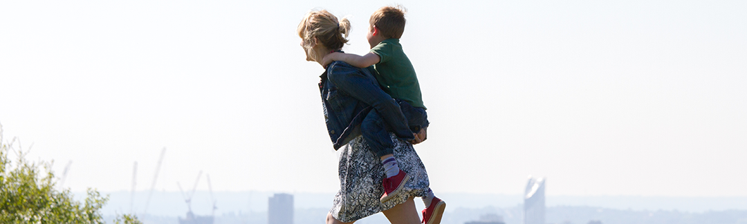 A woman carrying a child